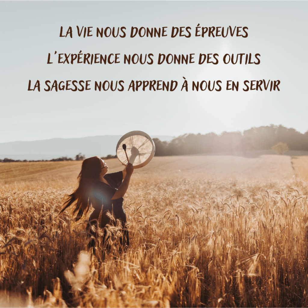 image montrant une thérapeute en constellations familiales et systémiques et un tambour chamanique au soleil couchant, dans un champ de blé près de Morges et Renens, dans le canton de Vaud, en Suisse romande