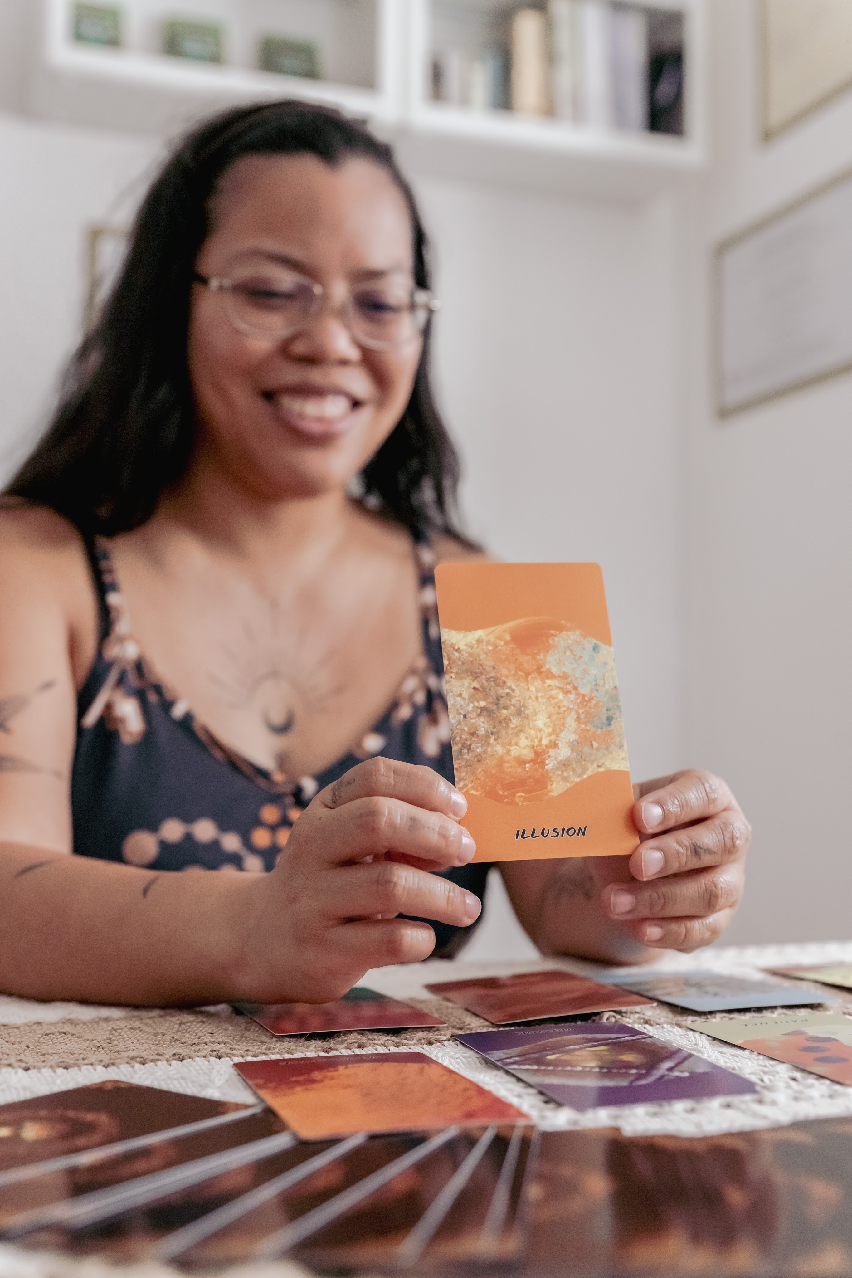 portrait d'une thérapeute en constellation familiale et systémique de groupe à Lausanne (Vaud, Suisse romande), donnant une consultation de psycho-tarot à l'aide d'un jeu d'orace auto-édité
